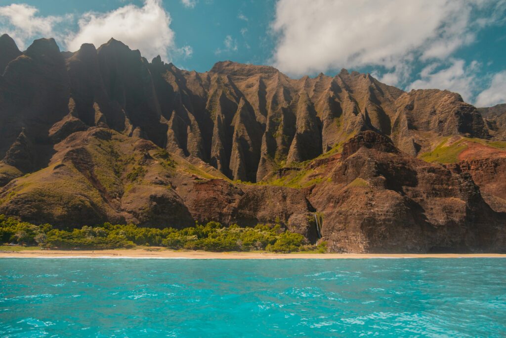 Discover the breathtaking Na Pali coastline with towering cliffs overlooking turquoise waters.