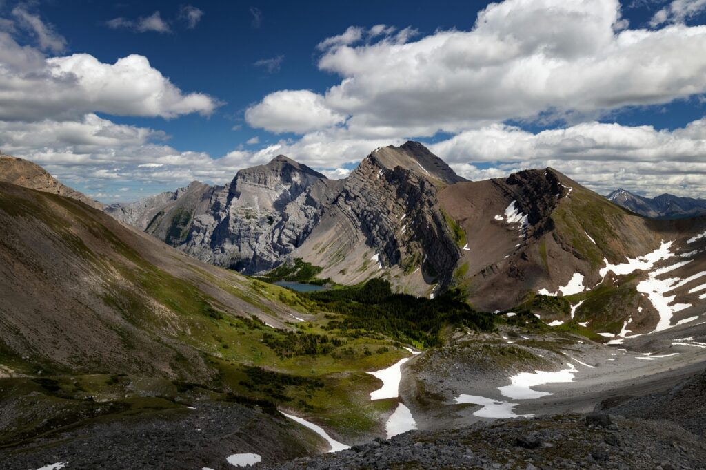 Breathtaking landscape of Mount Kidd with lush valleys and dramatic peaks under a clear summer sky.