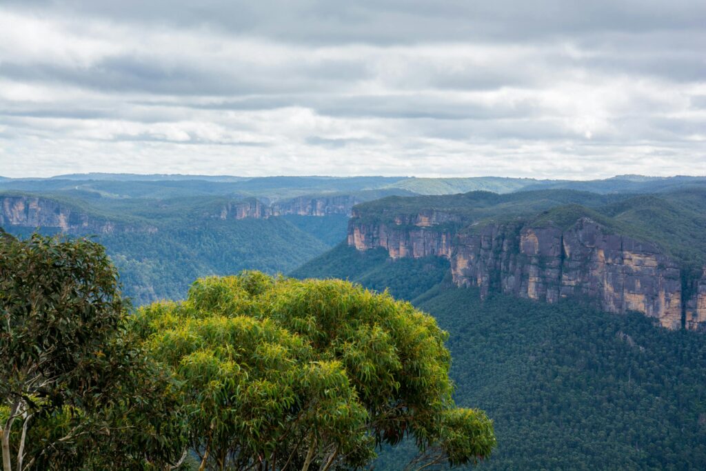 Breathtaking view of lush green mountains beneath a cloudy sky, showcasing nature's beauty.